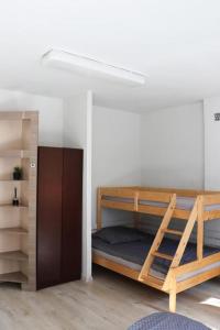 a room with two bunk beds and a closet at Helska Ostoya in Hel
