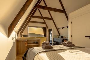 a bedroom with a bed with towels on it at Wild Atlantic Pods in Portmagee