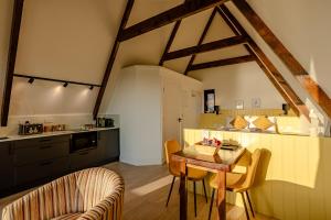 a kitchen with a table and chairs in a room at Wild Atlantic Pods in Portmagee