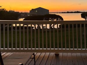 a bench on a deck with a view of the water at Blue House Getaway - 2BR 3BA Coastal Villa in Duck Key