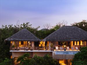 a resort with chairs and tables in front of it at 2024 - Villa Serena in Santa Cruz Huatulco