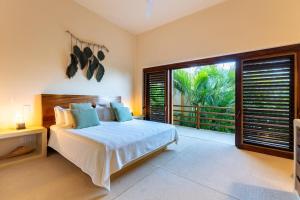 a bedroom with a bed and a large window at 2024 - Villa Serena in Santa Cruz Huatulco +50 photos