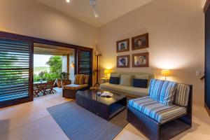 a living room with a couch and a table at 2024 - Villa Serena in Santa Cruz Huatulco