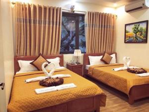 a hotel room with two beds with towels on them at Hoàng Phúc home - restaurant in Cat Ba