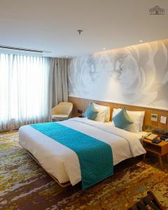 a hotel room with a large bed in a room at The Atlantiis Suites Nr Vishwanath Temple in Varanasi
