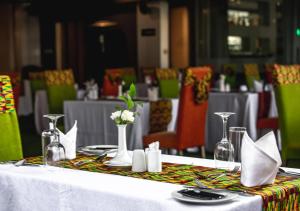 a table with a white table cloth and vases on it at The Atlantiis Suites Nr Vishwanath Temple in Varanasi