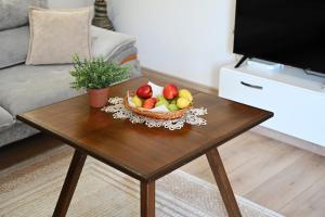 a bowl of fruit on a coffee table in a living room at The Parkside Villa Apartment II in Berat