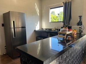 a kitchen with a stainless steel refrigerator at Casa do Bosque in Paty do Alferes