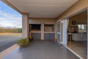 an empty house with a kitchen and a patio at Donkieshoek Accommodation & Campsite, Welgemoed Street, Calvinia in Calvinia +14 photos