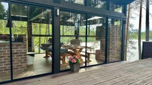 a conservatory with glass doors on a wooden deck at Villa Narikko in Sysmä +20 photos