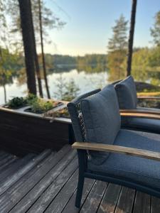 a blue chair sitting on a deck next to a boat at Villa Narikko in Sysmä