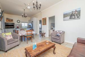 a living room with a couch and chairs and a table at Donkieshoek Accommodation & Campsite, Welgemoed Street, Calvinia in Calvinia
