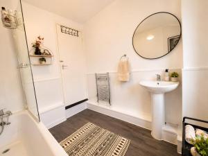 a white bathroom with a sink and a mirror at Room 2 Shared House 10 min from Center in Liverpool