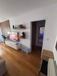 a living room with a flat screen tv and a couch at Fernández Vega 6 in Ponteareas +5 photos