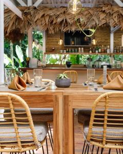 a dining room with a wooden table and chairs at Almonds & Corals Boutique Hotel in Puerto Viejo
