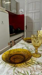 a table with two yellow plates on top of it at Loft Moderno 3 in Volta Redonda