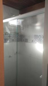 a shower with a glass door in a bathroom at Loft Moderno 3 in Volta Redonda