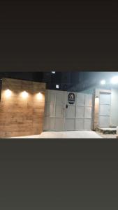 a garage with white doors and a sign on it at Loft Moderno 3 in Volta Redonda