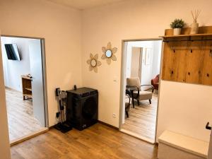 a living room with a stove and a mirror at Apartmán u Fary-Harmony in Adršpach