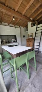 a green table and chairs in a kitchen at Cabane dans la vallée de Chamonix in Servoz +25 photos
