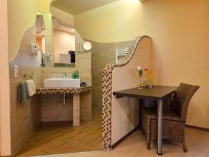 a bathroom with a sink and a mirror at Rosenhotel - Serviced Apartments in Zwentendorf +51 photos