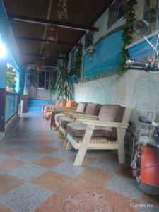 a row of benches lined up against a wall at Casa de vacanta ,,Puiu & Nelly,, in Sulina