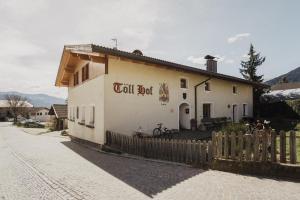 a small building with a fence in front of it at Töllhof STUDIO mit BAUERNSTUBE in Bressanone