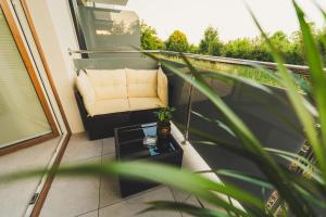a balcony with a chair and a table at Jacuzzi Siesławska Top Apartment in Busko-Zdrój