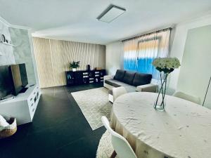 a living room with a table and a couch at Casa do Prado in Pontevedra
