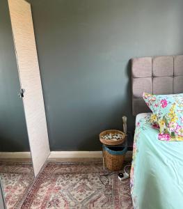 a bedroom with a bed and a basket next to a door at Eastbourne in Pevensey