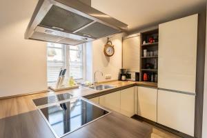 a kitchen with a sink and a counter top at Doppelhaushälfte OHANA in Böhl