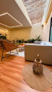 a room with a couch and a table with a vase at Nam Hotel Boutique Medellin in Medellín +1 photo