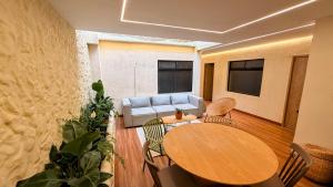 a living room with a table and a couch at Nam Hotel Boutique Medellin in Medellín