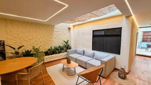 a living room with a couch and a table at Nam Hotel Boutique Medellin in Medellín