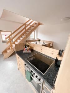 a kitchen with a counter top and a staircase at Ferienwohnung am Klöckhof in Marktoberdorf
