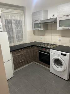 a kitchen with a washing machine and a washer at Zatorze in Tczew