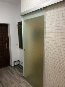 a sliding door in a room next to a brick wall at Zatorze in Tczew
