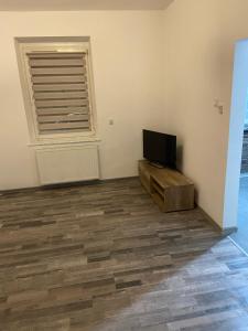 a living room with a television and a wooden floor at Zatorze in Tczew