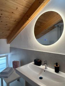 a bathroom with a white sink and a mirror at Ecoloft Radici in Poderia