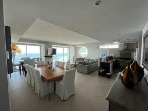 a kitchen and living room with a table and chairs at Bay View Grand Marina with jacuzzi- North Tower in Ixtapa