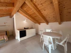 a kitchen and dining room with a table and chairs at Ecoloft Radici in Poderia +6 photos