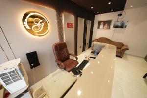a office with a chair and a desk with a phone at Hotel Ratan International in Raipur