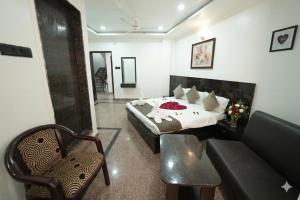 a hotel room with a bed and a couch at Hotel Ratan International in Raipur