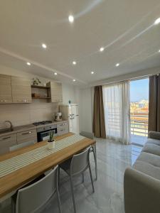 a kitchen and dining room with a table and chairs at Sikelia home in Giardini Naxos