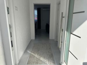 a hallway with two doors and a rug on the floor at Sarajevo Corner in Gladno Polje