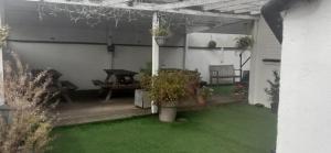a patio with potted plants and a picnic table at The Grafton Rooms in Northampton