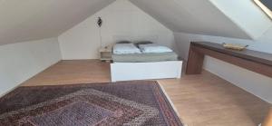 a bedroom with a bed and a rug in a attic at Sia Home in Vålberg
