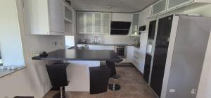 a kitchen with a black table and black refrigerator at Sia Home in Vålberg