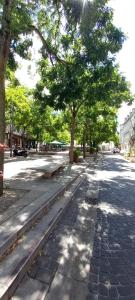 a tree lined street with a sidewalk and trees at Cas'ArtiGè in Troyes