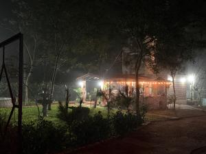 a house lit up at night with lights on it at Rancho Don Sina in Caacupé